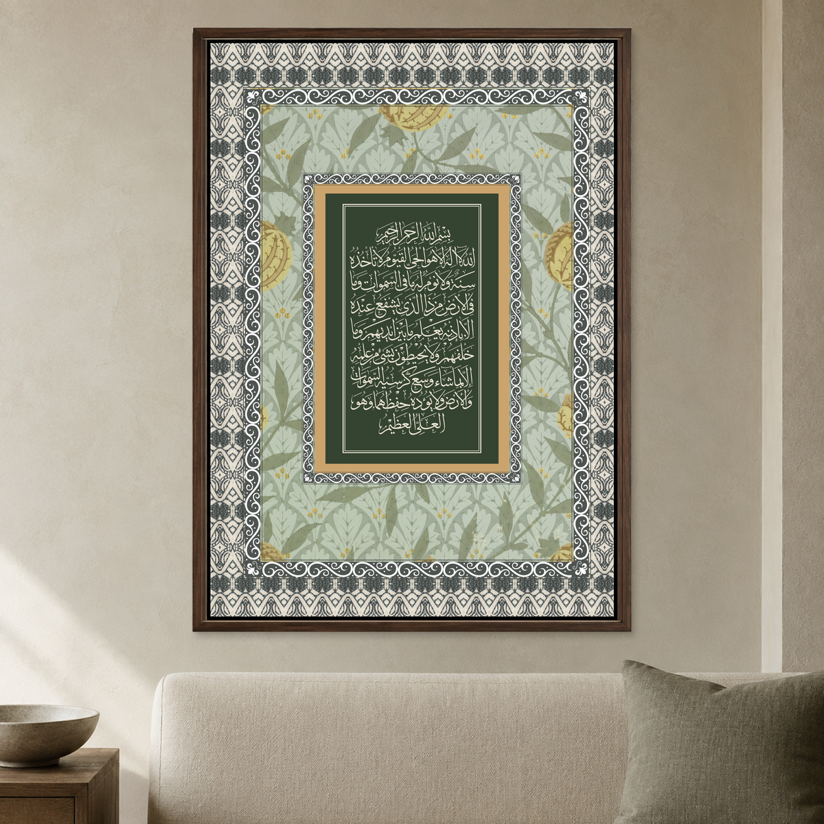 Vintage sage green Ayatul Kursi wall poster with patterned borders in a dark brown frame above a cream sofa